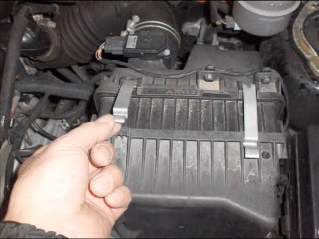 Отстегивание защелок корпуса воздушного фильтра Mitsubishi Outlander I 2003 - 2008